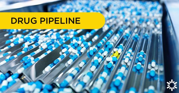 Drug Pipeline – Blue pills traveling through a sorting machine, a yellow pill stands out from the rest.