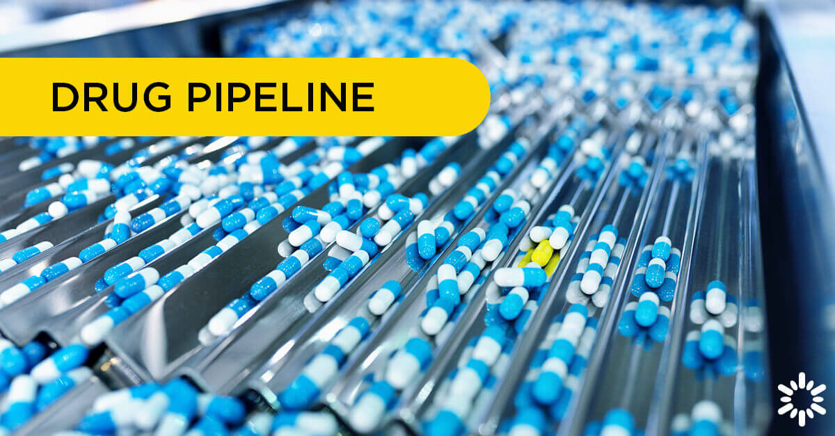 Drug Pipeline – Blue pills traveling through a sorting machine, a yellow pill stands out from the rest.
